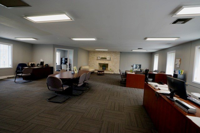 A spacious office with multiple desks and computers.